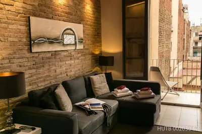 a living room with a couch and a brick wall at Alcam Molino in Barcelona
