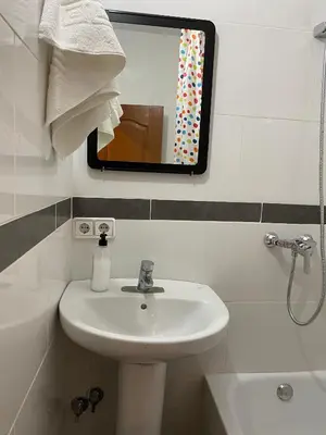 a bathroom with a sink and a mirror at Hostal Granvia 628 in Barcelona