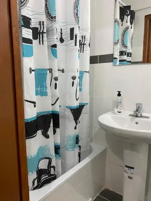 a bathroom with a sink and a shower curtain at Hostal Granvia 628 in Barcelona