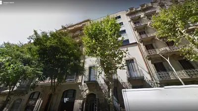 an apartment building with trees in front of it at Alcam Aribau in Barcelona