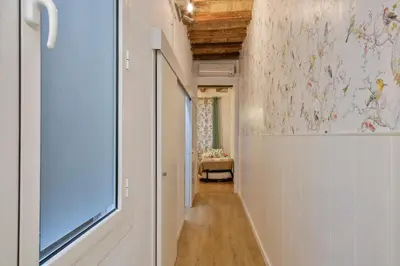 a hallway with a window and a wall with flowers at Alcam Gignas in Barcelona