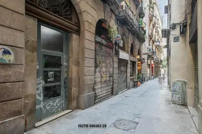 an empty alley way in a city with buildings at Alcam Gignas in Barcelona