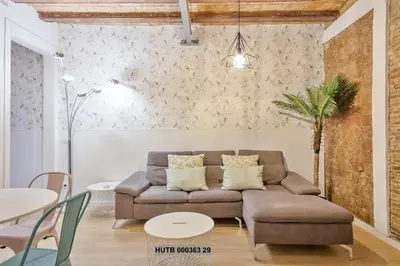 a living room with a couch and a table at Alcam Gignas in Barcelona