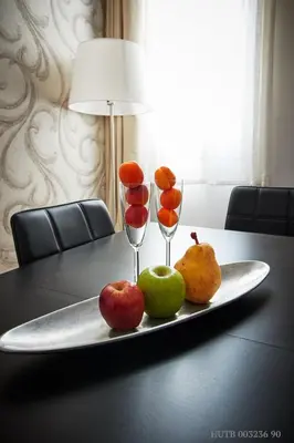 a tray with fruit and wine glasses on a table at Alcam Rizal in Barcelona