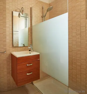 a bathroom with a sink and a mirror at Alcam Rizal in Barcelona