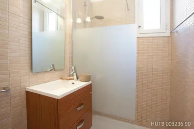 a bathroom with a sink and a mirror at Alcam Rizal in Barcelona