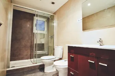 a bathroom with a toilet and a shower and a sink at Alcam Valencia II in Barcelona