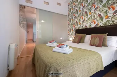 a bedroom with a large bed with towels on it at Alcam Montjuic in Barcelona