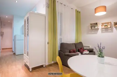 a living room with a white table and a couch at Alcam Montjuic in Barcelona