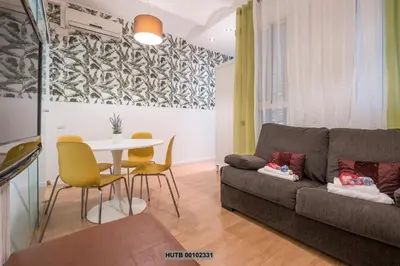 a living room with a couch and a table at Alcam Montjuic in Barcelona