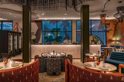 a restaurant with tables and chairs and a bar at Vincci Gala in Barcelona