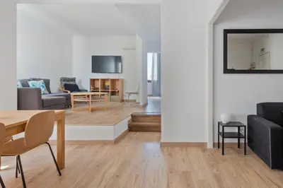 a living room and dining room with a table and chairs at Blau Atic Apartment in Barcelona