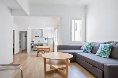 a living room with a couch and a table at Blau Atic Apartment in Barcelona