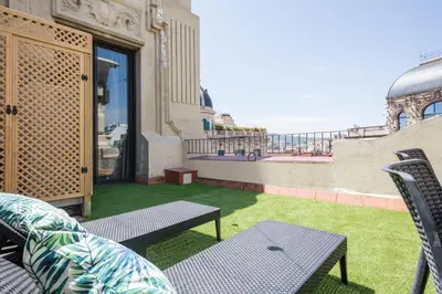 a balcony with a table and chairs and the ocean at Blau Atic Apartment in Barcelona