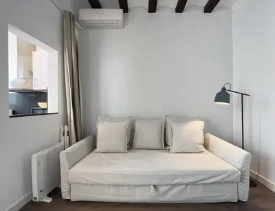 a white couch with pillows in a room at Stay U-nique Apartments Vila de Gracia in Barcelona