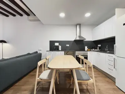 a kitchen and dining room with a table and a couch at Stay U-nique Apartments Vila de Gracia in Barcelona