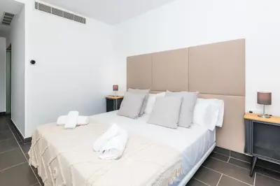 a bedroom with a large bed with white sheets and pillows at Villa Miramar by Glasir in Sitges