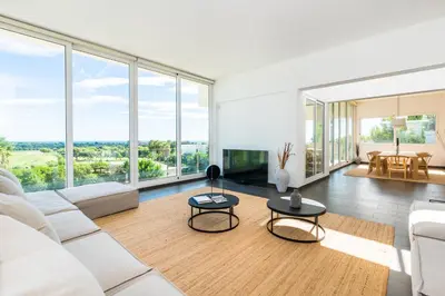 a living room with white furniture and large windows at Villa Miramar by Glasir in Sitges