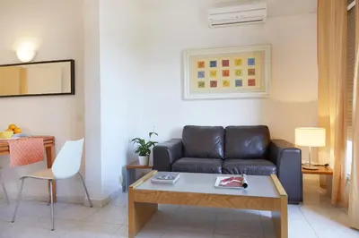 a living room with a couch and a table at Apartamentos Calvet in Barcelona