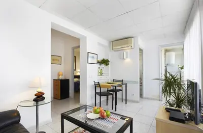 a living room with a couch and a table at Apartamentos Calvet in Barcelona