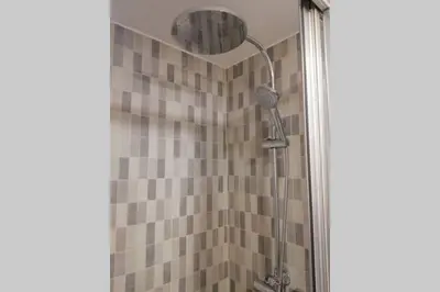 a shower with a shower head in a bathroom at M1 Cool Loft 1 min walk to metro 15 min center by metro in Esplugues de Llobregat