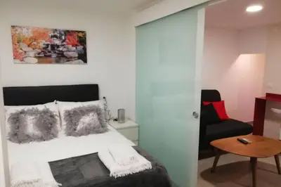 a bedroom with a bed and a couch and a table at M1 Cool Loft 1 min walk to metro 15 min center by metro in Esplugues de Llobregat