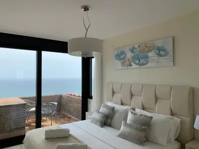 a bedroom with a large bed and a large window at Sitges Spaces Sea View Villa- 6 Bedrooms, 5 bathrooms, 2 private pools, Near center in Sitges