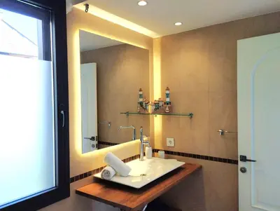 a bathroom with a sink and a large mirror at Sitges Spaces Sea View Villa- 6 Bedrooms, 5 bathrooms, 2 private pools, Near center in Sitges