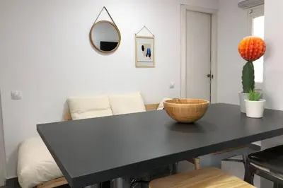 a black table with a bowl on it in a living room at M4 Cool Terrace. 1 min to metro. 15 min to center in Esplugues de Llobregat