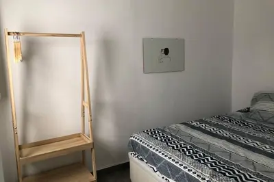 a bedroom with a mirror next to a bed at M4 Cool Terrace. 1 min to metro. 15 min to center in Esplugues de Llobregat