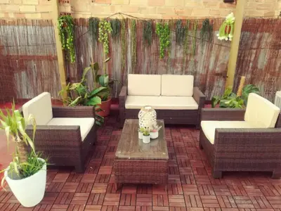 a patio with two couches and a table and plants at M2 Cool apartment next to metro. 15m to center in Esplugues de Llobregat