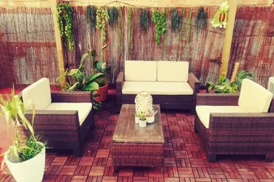 a patio with two couches and a table and plants at M2 Cool apartment next to metro. 15m to center in Esplugues de Llobregat