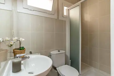 a bathroom with a white toilet and a sink at 731 - AB Enric Granados Apartment in Barcelona