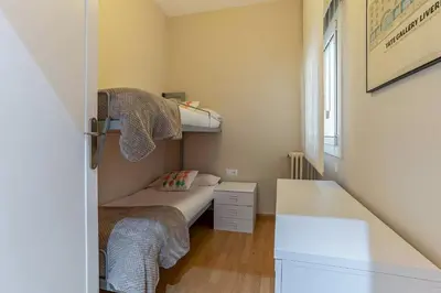 a small bedroom with a bunk bed and a desk at 731 - AB Enric Granados Apartment in Barcelona