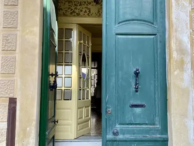 a green door in a building with a yellow door at El masnou in Masnou