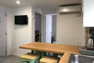 a kitchen with a wooden table and a sink at M3 Terrace. Cool apartment 15 min center by metro in Esplugues de Llobregat