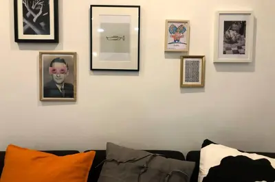 a room with a couch and framed pictures on a wall at M5 Cool Terrace. Metro 1 min. Center 15' by metro in Esplugues de Llobregat