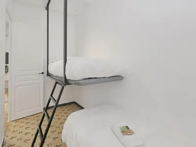 a room with a bunk bed with a ladder at Casa nanit apt c in Hospitalet de Llobregat