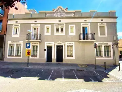 a large building with a parking lot in front of it at Casa nanit apt d in Hospitalet de Llobregat