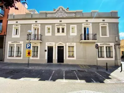 a large white building with a parking lot in front of it at Casa nanit apt d in Hospitalet de Llobregat