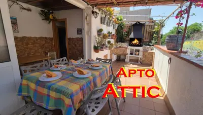 a table with plates of food on it on a patio at Attic, Walk to Park Güell, Sagrada Familia, Metro nearby in Barcelona