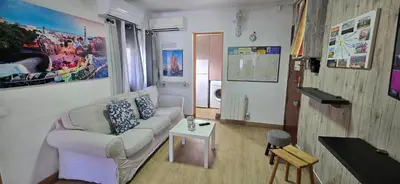 a living room with a couch and a table at Attic, Walk to Park Güell, Sagrada Familia, Metro nearby in Barcelona