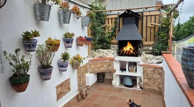 a patio with a fire pit and potted plants at Attic, Walk to Park Güell, Sagrada Familia, Metro nearby in Barcelona