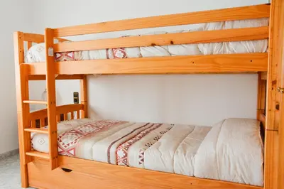 two bunk beds in a small room with a bed at Masia Cal Tonarro in San Martín Sarroca