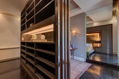 a room with a wall with black shelves at SuiteaBcn II in Barcelona