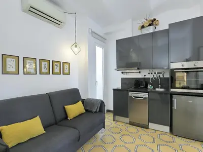 a living room with a couch and a kitchen at Casa nanit apt b in Hospitalet de Llobregat