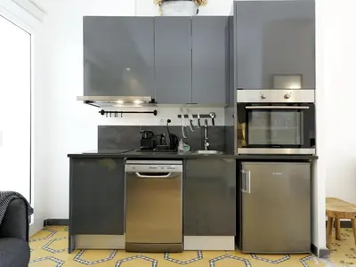 a kitchen with stainless steel appliances in a room at Casa nanit apt b in Hospitalet de Llobregat