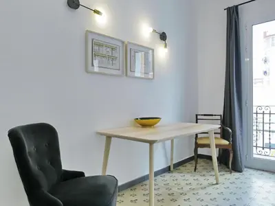 a dining room with a table and a chair at Casa nanit apt b in Hospitalet de Llobregat
