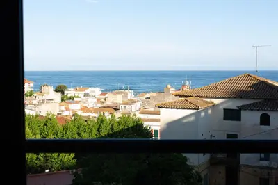 a view from a window of a city with the ocean at Apartaments Voralmar in Caldes d'Estrac