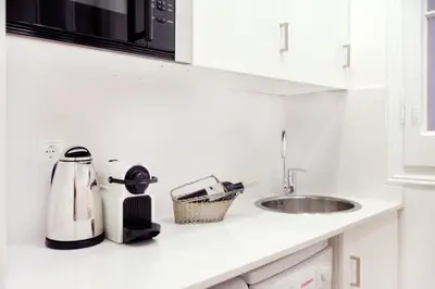 a kitchen counter with a sink and a microwave at Casa Valeta in Barcelona